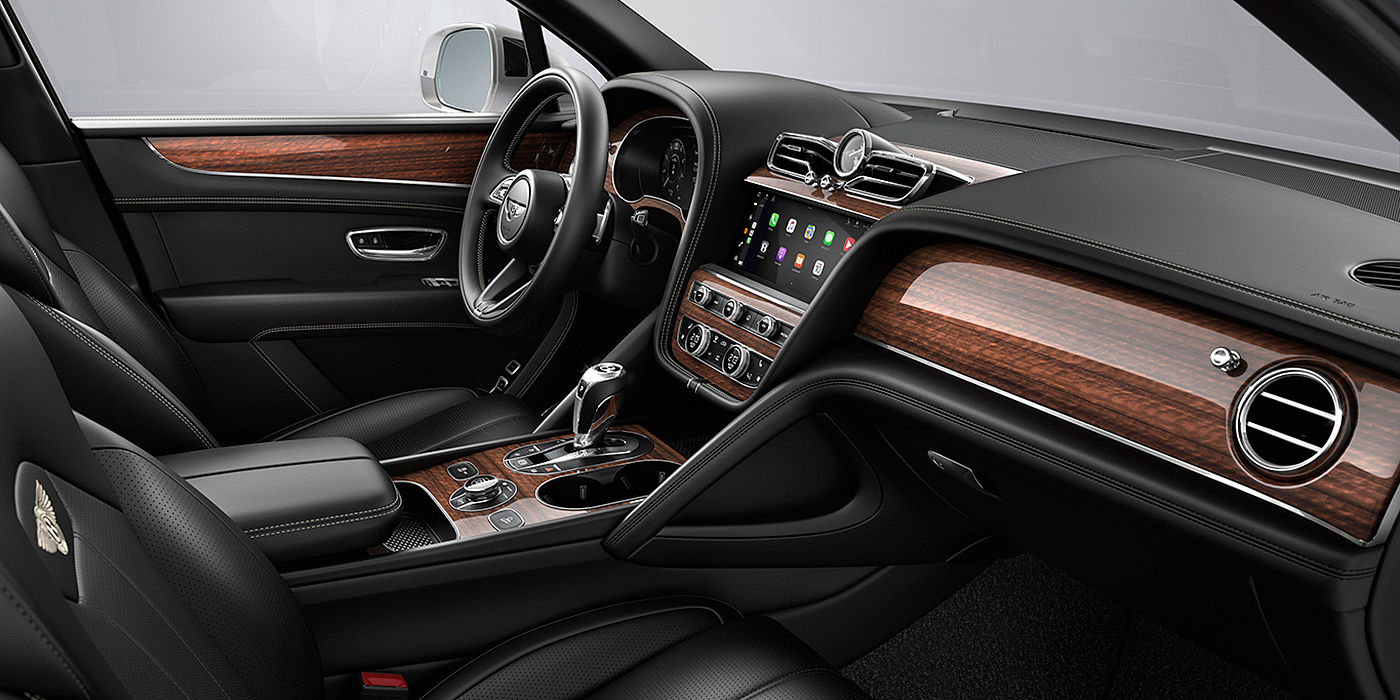 Bentley Bangkok Bentley Bentayga interior with a Crown Cut Walnut veneer, view from the passenger seat over looking the driver's seat.