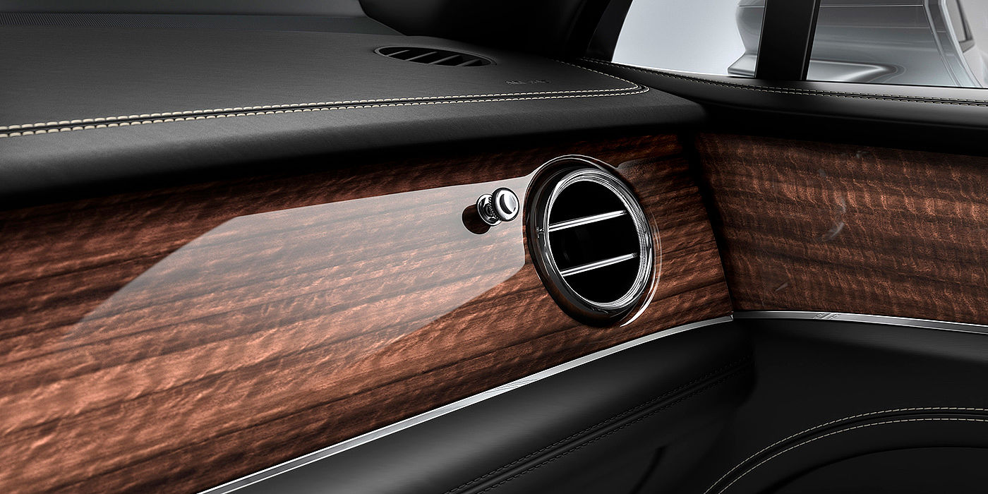 Bentley Bangkok Bentley Bentayga front interior Crown Cut Walnut veneer and chrome air vent.