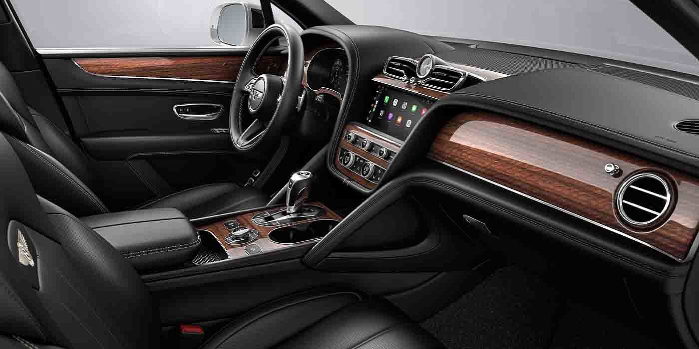 Bentley Bangkok Bentley Bentayga EWB interior with a Crown Cut Walnut veneer, view from the passenger seat over looking the driver's seat.
