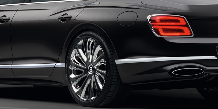 Bentley Bangkok Bentley Flying Spur Mulliner sedan rear side exterior detail in Magnetic paint and 22 inch Mulliner painted and polished wheel