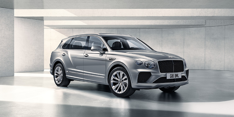Bentley Bangkok Bentley Bentayga Extended Wheelbase SUV front three quarter in Moonbeam paint with a grey background