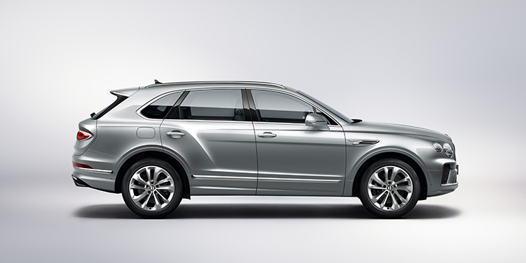 Bentley Bangkok Bentley Bentayga SUV side profile in Moonbeam silver paint against white background featuring 21 inch 5 spoke wheels