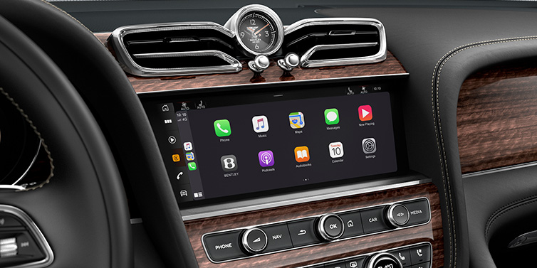 Bentley Bangkok Bentley Bentayga Extended Wheelbase SUV front interior centre console MMI screen showing apps surrounded by Beluga black hide and Crown Cut Walnut veneer