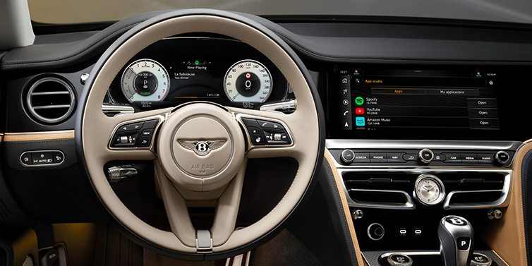 Bentley Bangkok Bentley Flying Spur Mulliner sedan front interior detail of steering wheel and driver screens surrounded by Linen and Beluga black hides