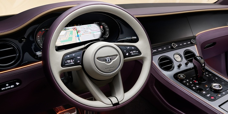 Bentley Bangkok Bentley Continental GT Mulliner coupe front interior showing steering wheel and drivers screens surrounded by Linen and Damson hides and Grand Black veneer
